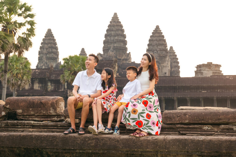 Parents and children posing at Angkor Wat with professional photographer