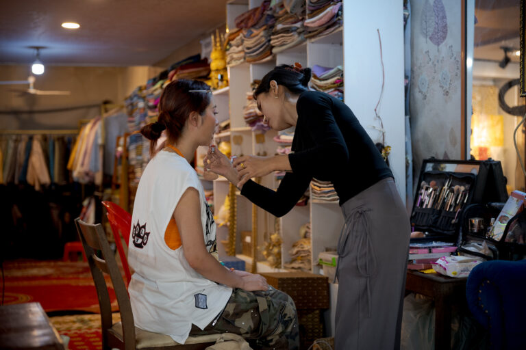 Makeup being applied before a traditional Cambodian dress photoshoot